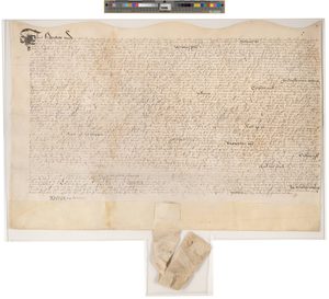 A large oblong document with a tag covered in handwriting
